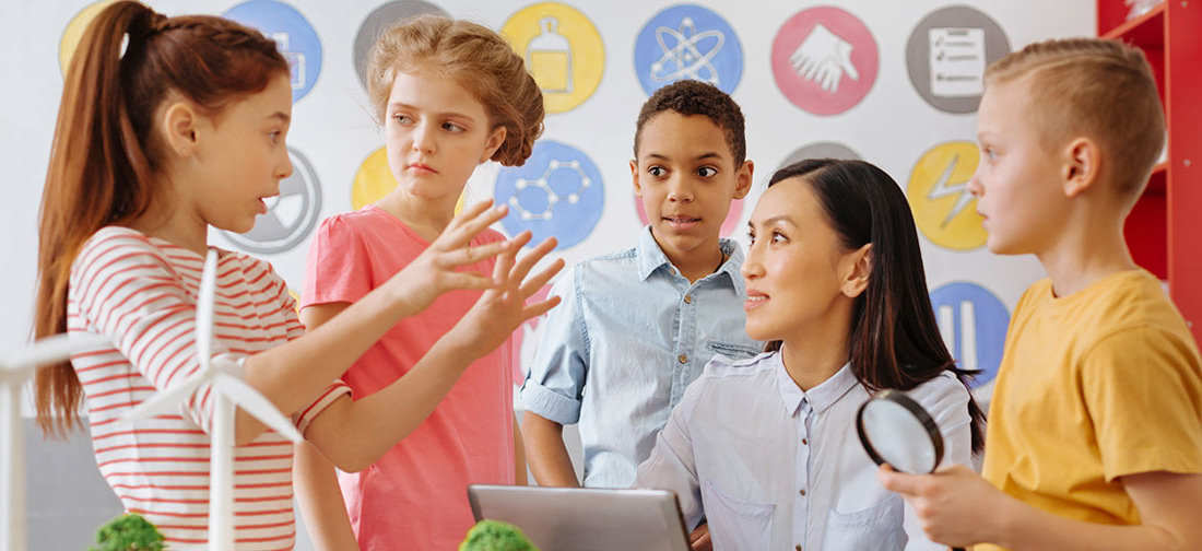 Teacher with young children discussing